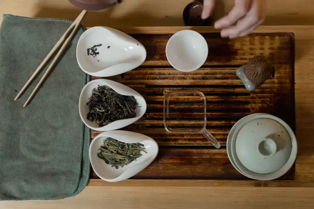 Dried specialty tea leaves arranged on a minimalist tasting tray