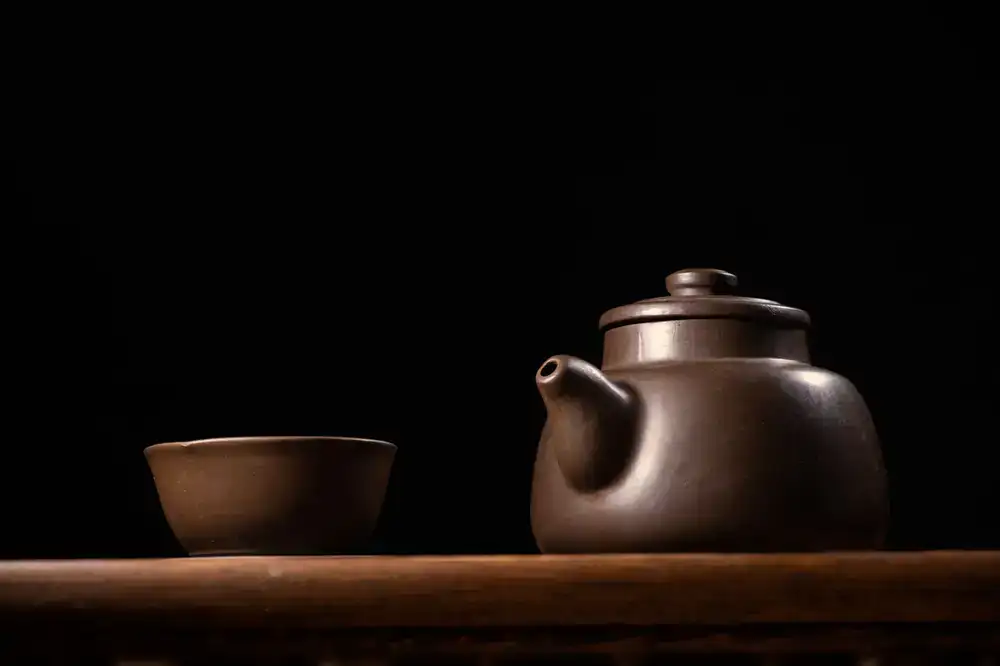 A minimal ceramic teapot and tasting cups