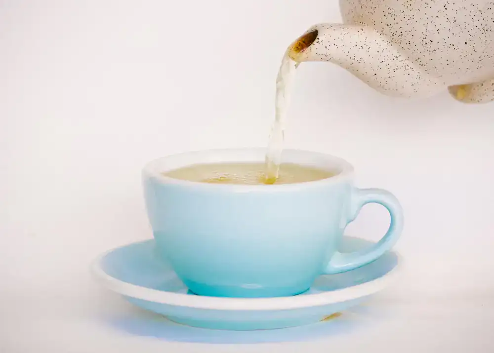 A perfectly brewed cup of specialty tea being poured