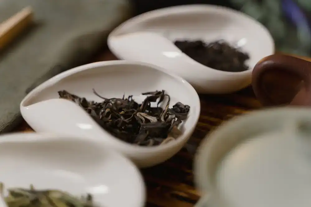 Dark roasted oolong leaves in a porcelain bowl