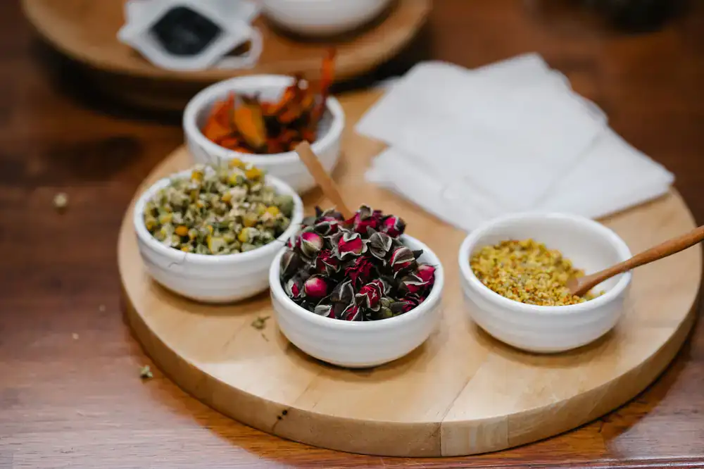 Dry tea leaves presented on a small ceramic tray